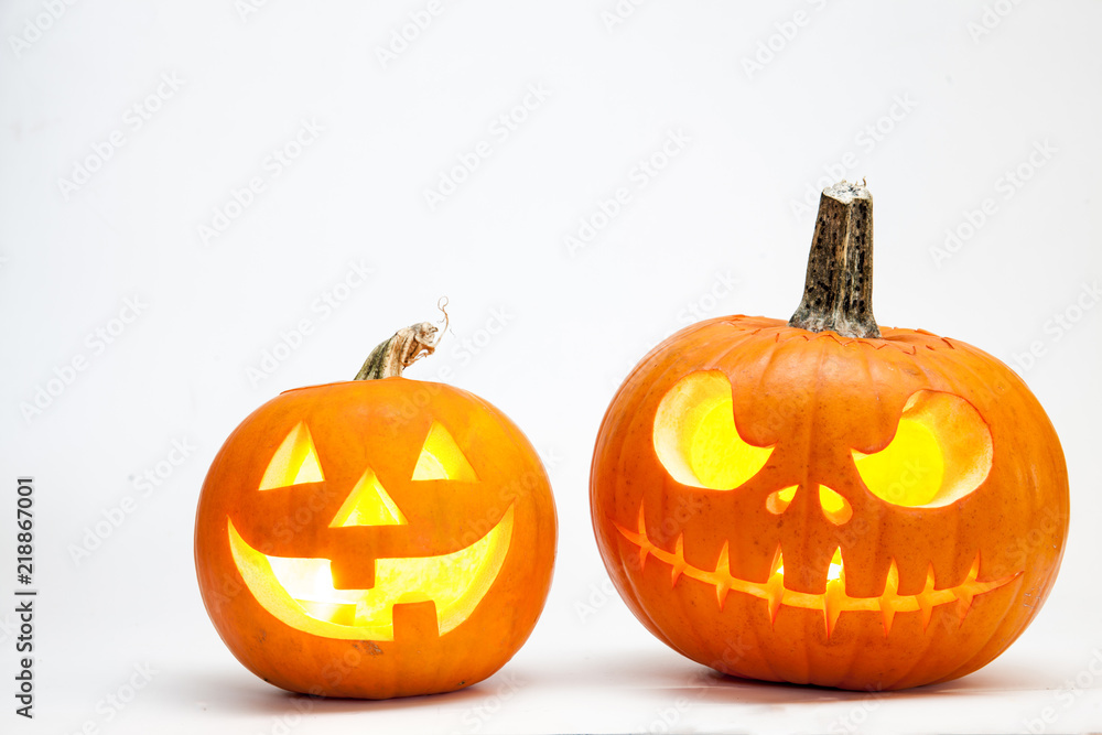 Obraz premium Two Halloween pumpkin head jack lantern with burning candles isolated on white background