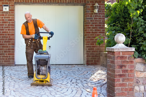 Installation of brick pavers on a driveway. photo