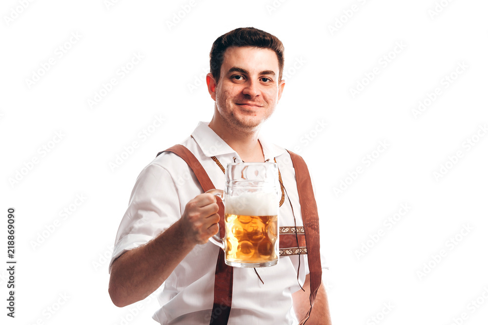 Man in traditional bavarian clothes holding mug of beer Man in traditional bavarian clothes holding mug of beer