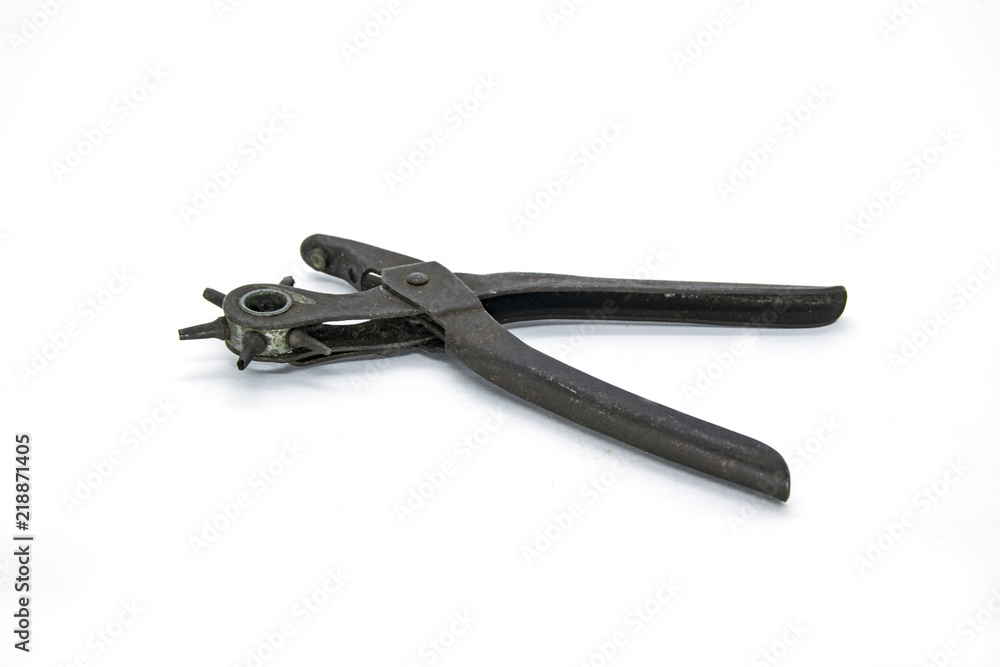Equipment tool to pierce leather belt isolated in white background Equipment tool to pierce leather belt isolated in white background