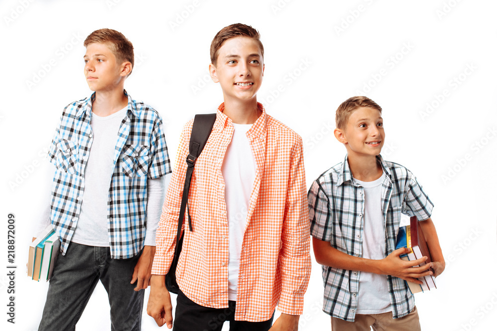 Boys teenagers, students or schoolchildren, on a white background in the Studio, go to school, preparing for the school day Boys teenagers, students or schoolchildren, on a white background in the Studio, go to school, preparing for the school day