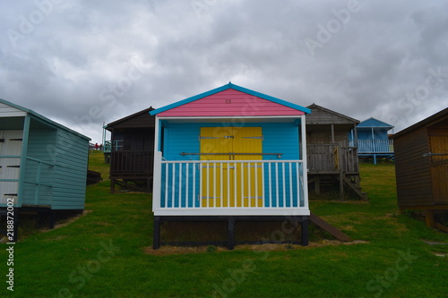 Colourful beach huts on the Whitstable seafront promenade. Whitstable, Kent, UK © Rusana