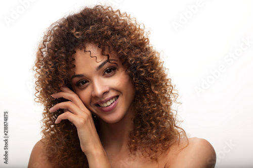close-up portrait of a beautiful young woman with wavy hair.