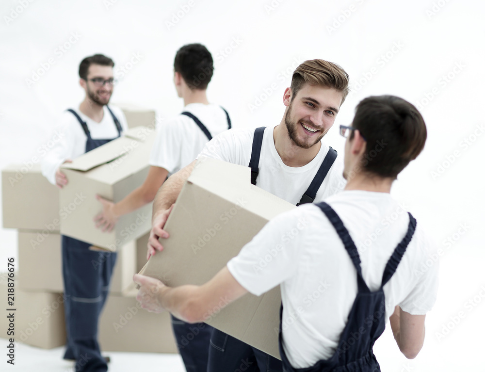 Portrait of movers holding box smiling isolated on white backgro Portrait of movers holding box smiling isolated on white backgro