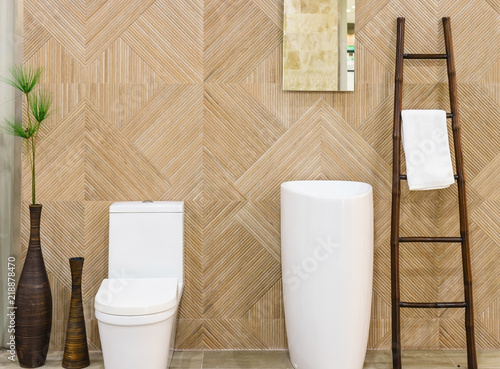 Modern spacious bathroom with bright tiles with toilet and sink.