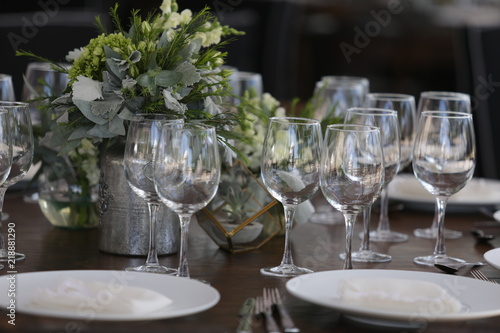 elegant Table decoration with wine glasses  glasses  forks  ornaments  ready to serve in event  wedding  celebration  xv years  baptism