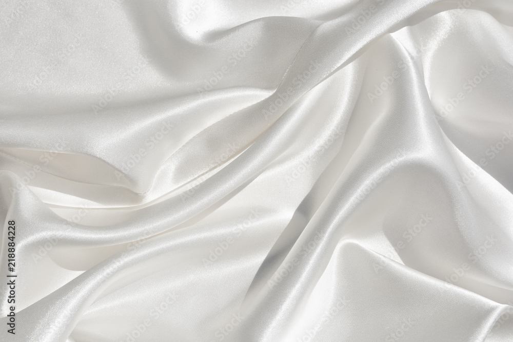 The texture of the satin fabric of white color for the background The texture of the satin fabric of white color for the background