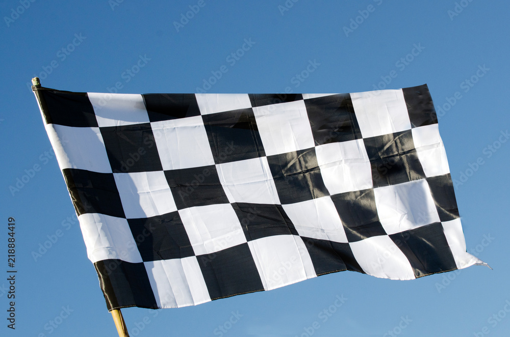 Checkered flag isolated on blue sky background