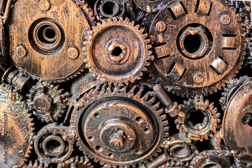 Selective focus of gears from a machine background.
