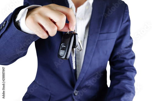 Businessman offering a car key,Close up of hand showing key of automobile..