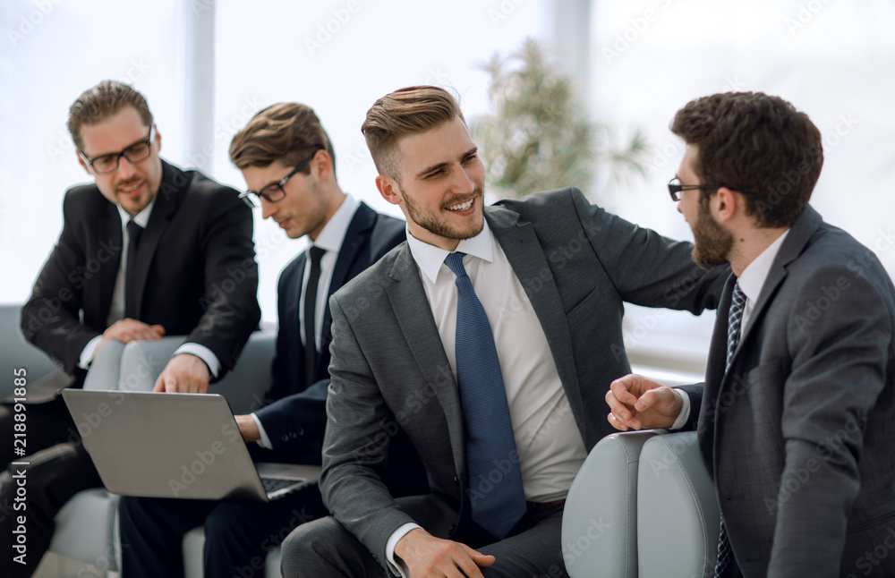 business colleagues talk sitting in the office lobby business colleagues talk sitting in the office lobby