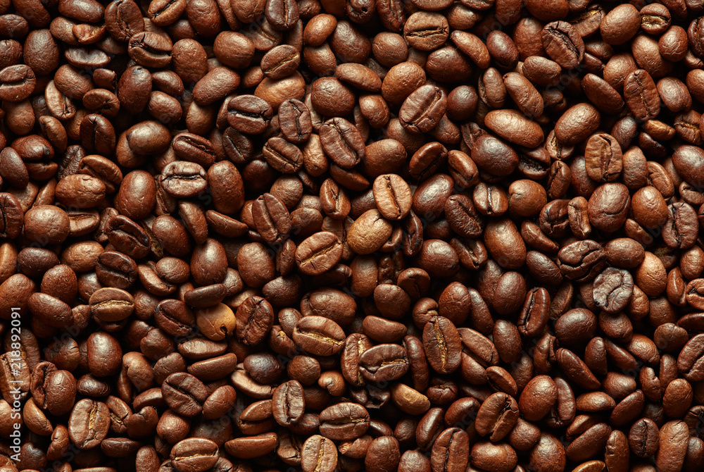top view of heap of roasted coffee beans as textured background top view of heap of roasted coffee beans as textured background