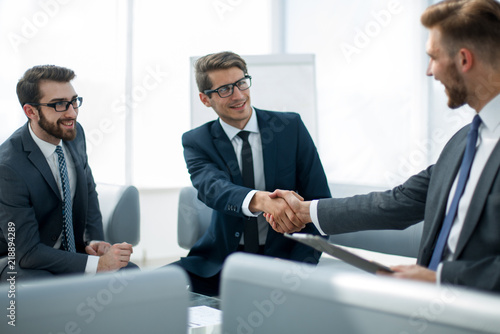 handshake business partners at the negotiating table photo