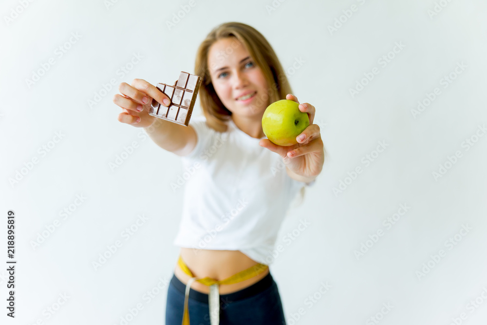 Fit woman measuring waist with measuring tape Fit woman measuring waist with measuring tape
