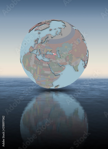 Fototapeta Naklejka Na Ścianę i Meble -  Georgia on globe above water surface