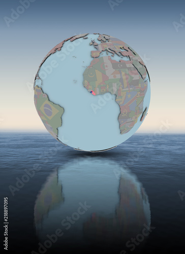 Liberia on globe above water surface