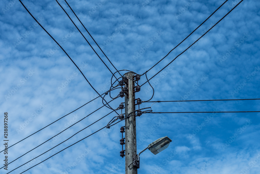 electric wire and lamp on electrical pole with blue cloudy sky background electric wire and lamp on electrical pole with blue cloudy sky background