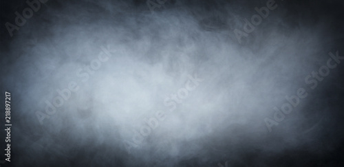 Grey smoke over black background. Abstract background.