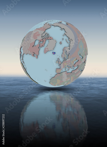 Fototapeta Naklejka Na Ścianę i Meble -  Iceland on globe above water surface