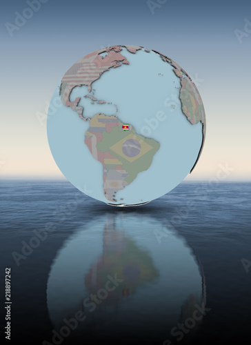 Fototapeta Naklejka Na Ścianę i Meble -  Suriname on globe above water surface