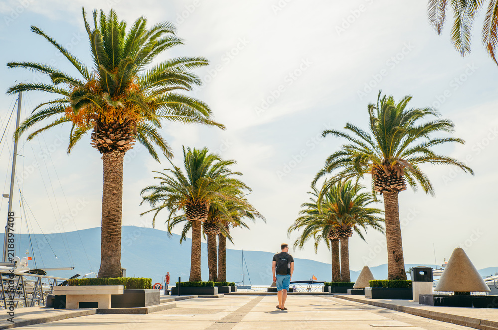 Fototapeta premium man walking by pier in summer day