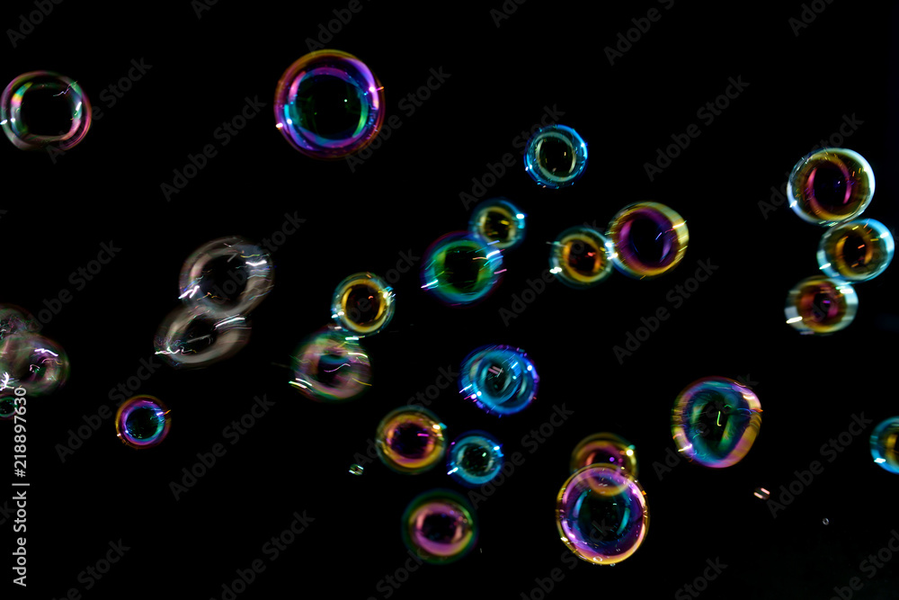 Soap bubbles on a dark background in motion. Soap bubbles on a dark background in motion.