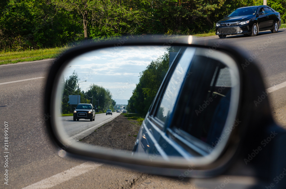 Road in sideview mirror of a car , on road countryside.