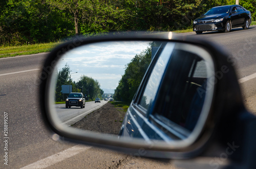 Road in sideview mirror of a car , on road countryside.