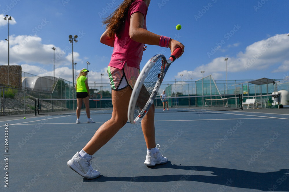 Girl playing tennis on a court