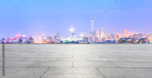 Empty square floor and modern city skyline in Beijing at night