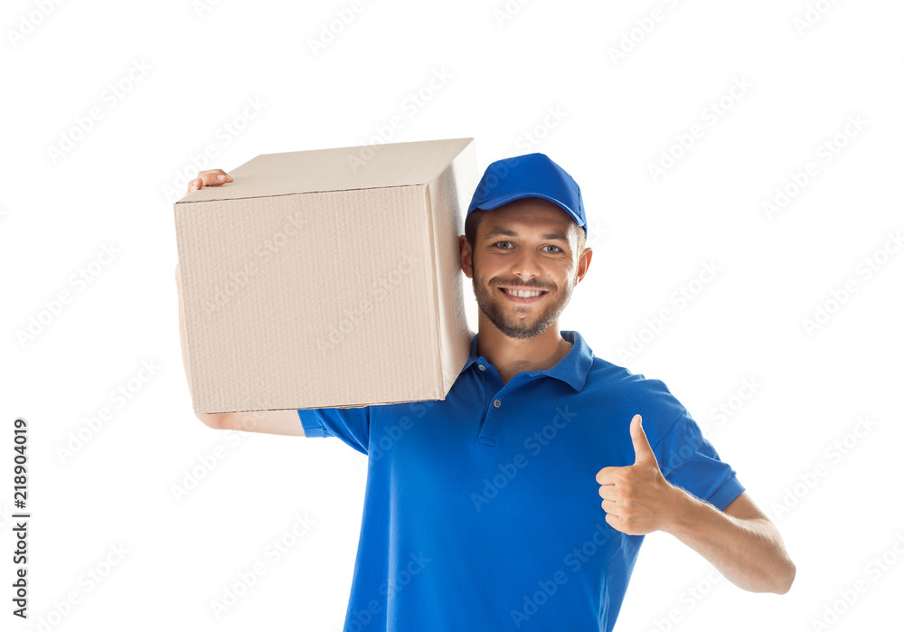 Smiling young delivery man with parcel box showing thumbs up Smiling young delivery man with parcel box showing thumbs up
