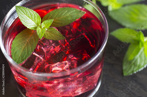 Refreshing grenadine drink with ice and mint, top view