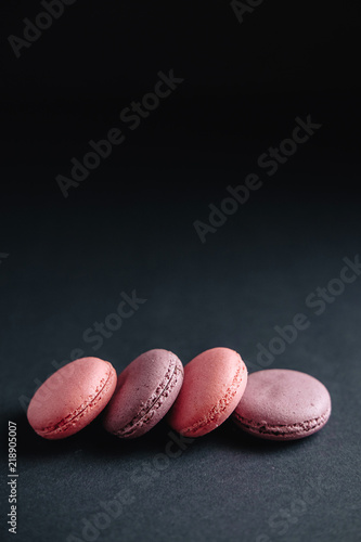 pink macarones on dark background © denisval