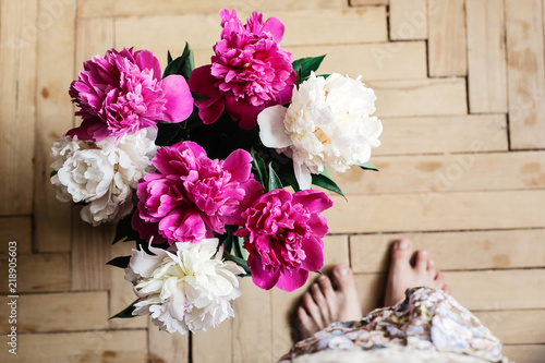 beautiful bunch of peonies in vase on wooden background, rustic wallpaper concept, space for text © sonyachny