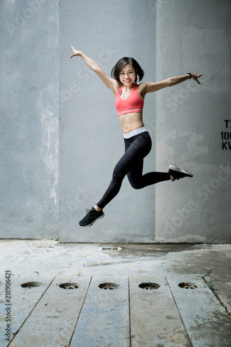 Fototapeta Naklejka Na Ścianę i Meble -  Happy young woman jumping