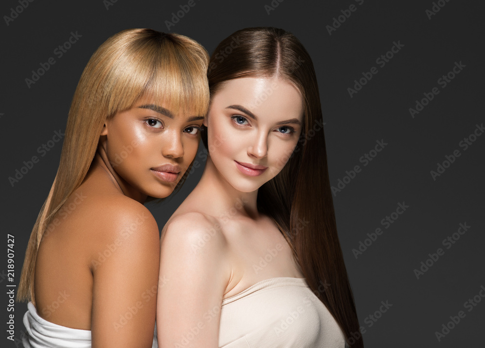 Ethnic beauty skin two women beauty face healthy skin and different colors african and caucasian Ethnic beauty skin two women beauty face healthy skin and different colors african and caucasian