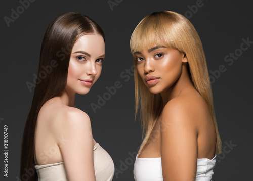 Ethnic beauty skin two women beauty face healthy skin and different colors african and caucasian photo