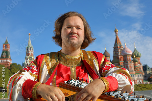 Musician with music instrument gusli photo