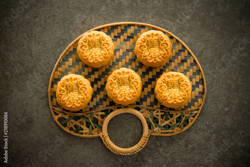 Mooncakes on bamboo background dark light with copyspace