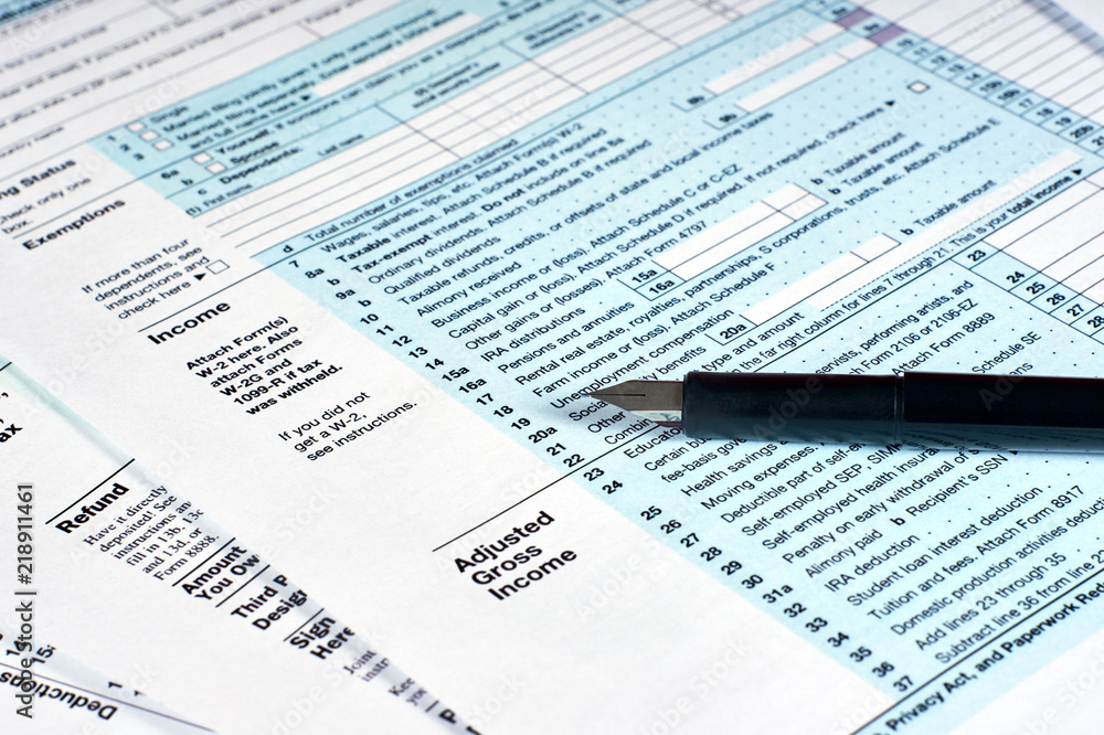 Tax reporting and pen. Filling out tax forms Tax reporting and pen. Filling out tax forms
