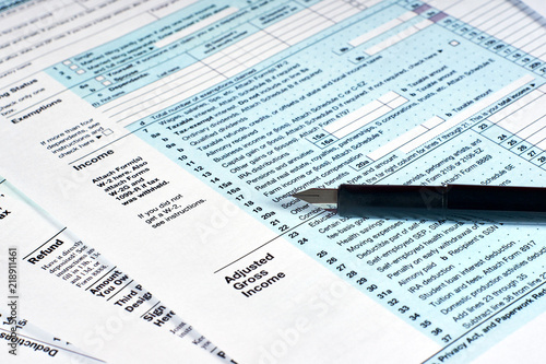 Tax reporting and pen. Filling out tax forms