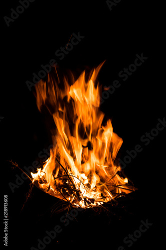 Great bright flame of fire. Burning firewood in the fire at night, the texture of fire and flame.
