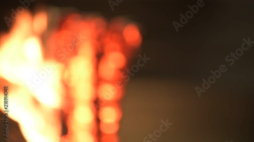 Burning wood with flames and glowing heat at night in the city 