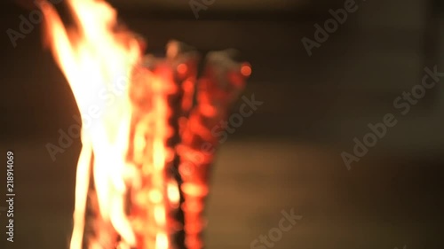 Burning wood with flames and glowing heat at night in the city 