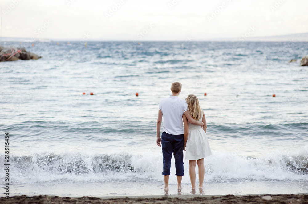 Young couple in love stands embracing against the sea in Sorrento. Young couple in love stands embracing against the sea in Sorrento.