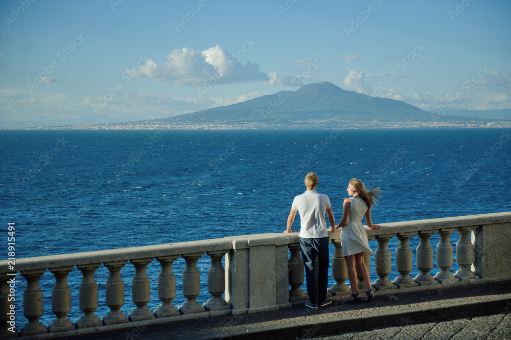 Young romantic couple on a background of a sea landscape and Vesuvius, Naples, Italy