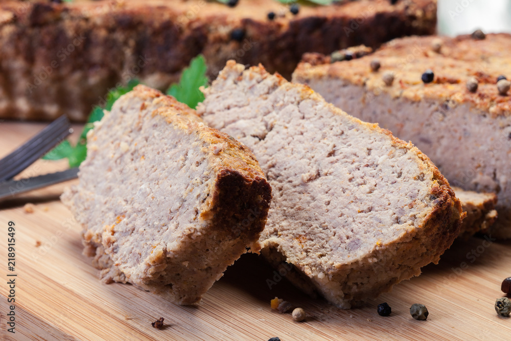 Traditional delicious meat pate with chicken liver on cutting board Traditional delicious meat pate with chicken liver on cutting board