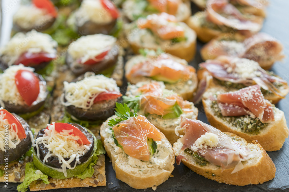 Gourmet appetizers: caviar, venison, tuna and salmon.