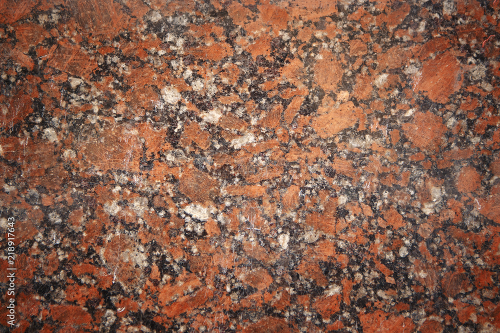 Red granite slab closeup may be used as background zoom in detail Red granite slab closeup may be used as background zoom in detail