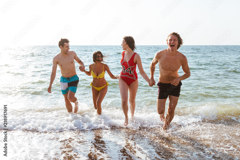 Group of friends having fun on the beach outdoors. Group of friends having fun on the beach outdoors.